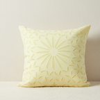 Decorative applique cushion cover with sunburst pattern on a neutral background
