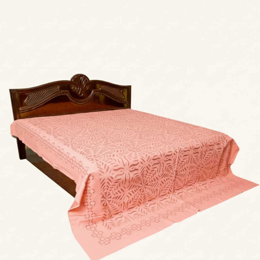 Bed with a floral-patterned bedspread and wooden headboard on a white background