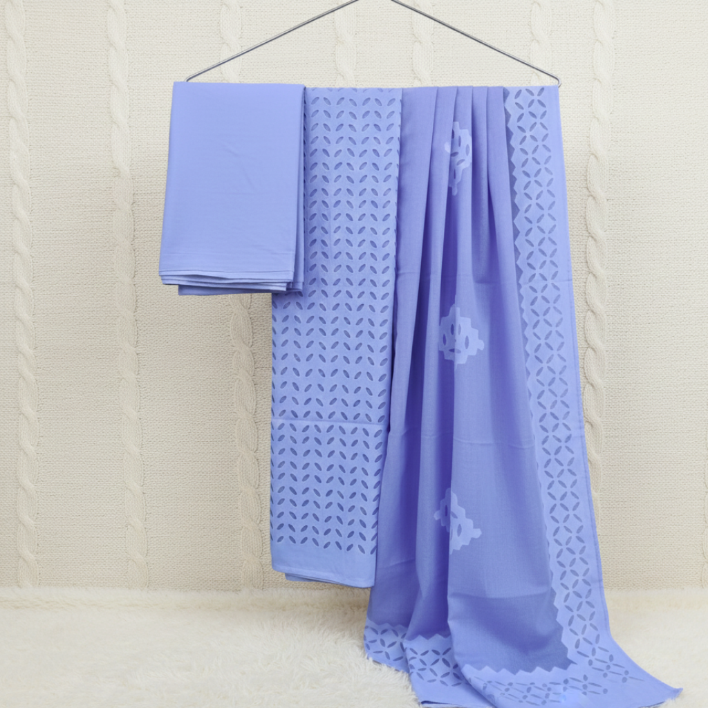 Light blue fabric with intricate patterns on a beige background