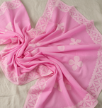 Pink fabric with floral patterns on a light background