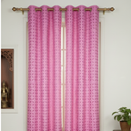 Pink curtains with a geometric pattern hanging in front of a window.
