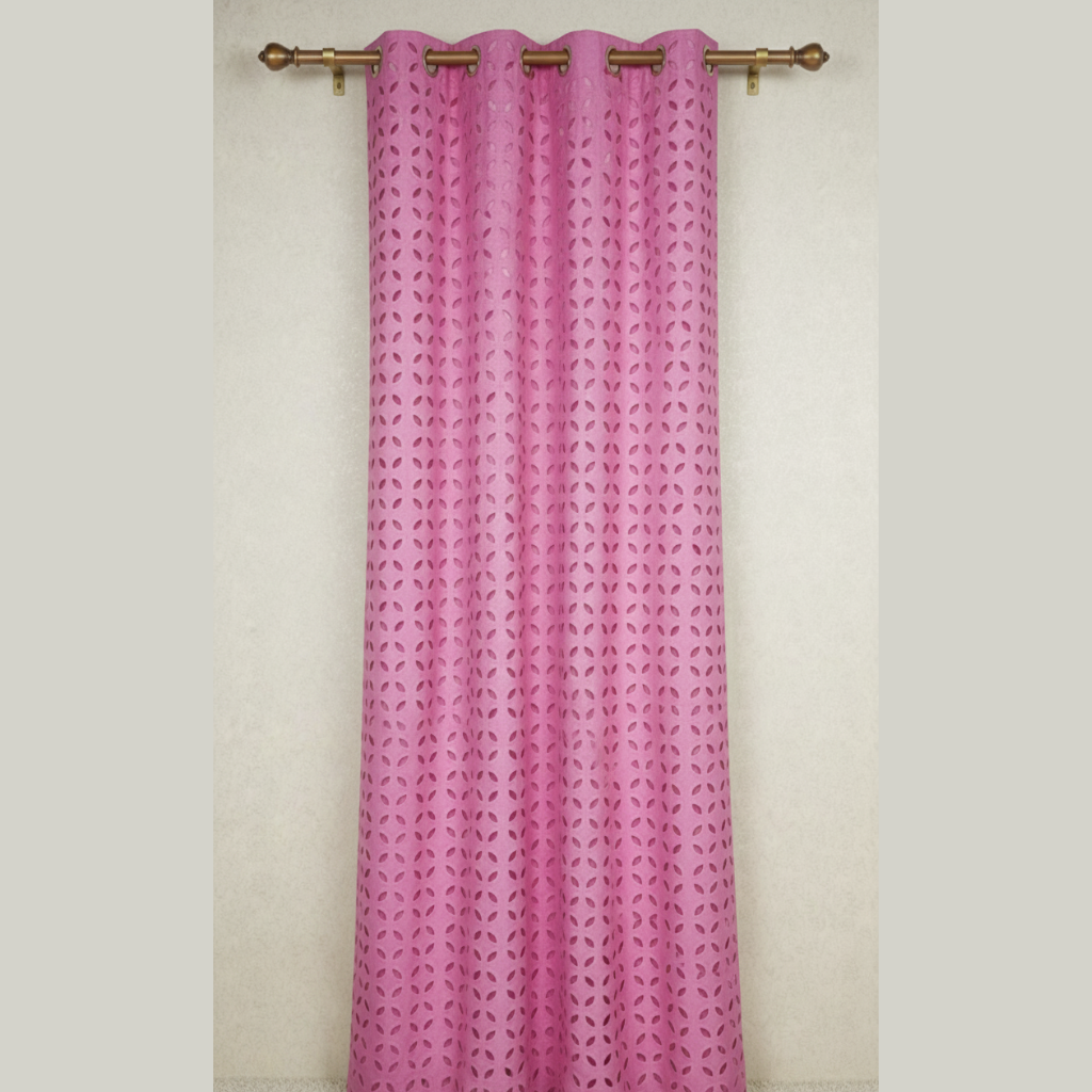 Pink curtain with a geometric pattern on a white wall
