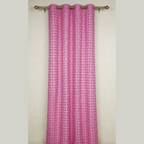 Pink curtain with a geometric pattern on a white wall