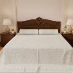 Bed with wooden headboard and white quilt in a bedroom setting