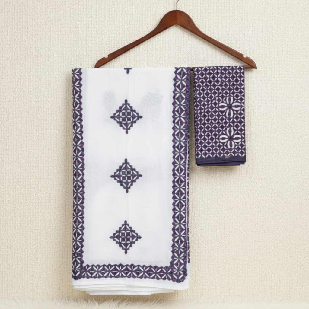 White fabric with purple geometric patterns on a hanger against a beige background