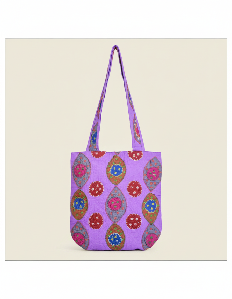 Purple tote bag with floral patterns on a beige background
