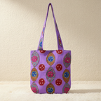 Purple tote bag with colorful patterns on a beige background