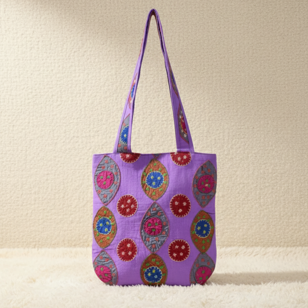 Purple tote bag with colorful patterns on a beige background