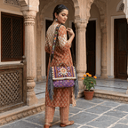 a woman in a suitset holding a purple banjara bag