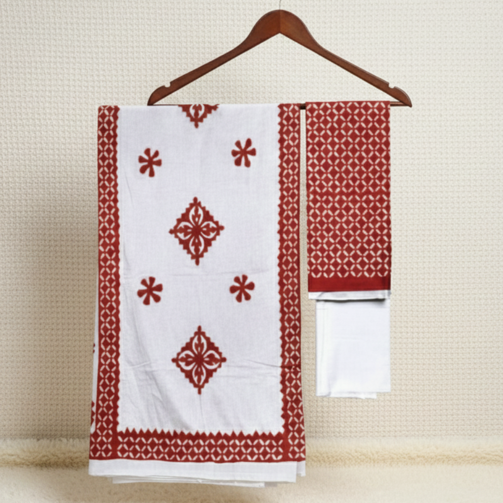 Red and white patterned fabric on a hanger against a beige wall