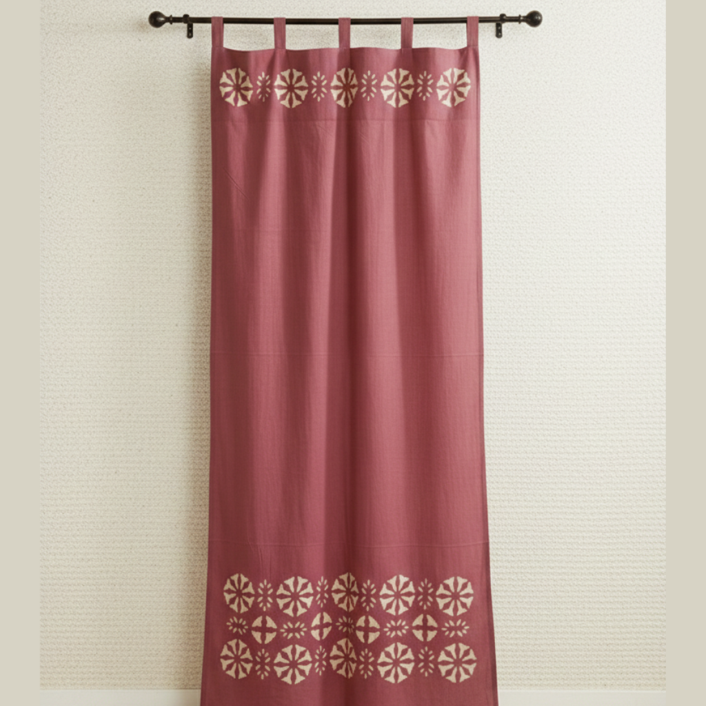 Red curtain with geometric patterns on a beige wall