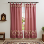 red curtains with gold patterns in a room with a window, plant, and decorative items.