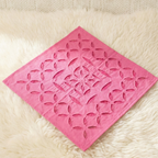 Pink napkin with a geometric pattern on a white textured surface