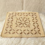 beige placemat with a starburst pattern on a textured surface