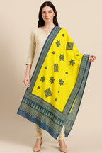 Woman wearing a yellow dupatta with applique green patterns