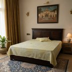 Bedroom with a tree applique bedsheet with matching pillows, decorative headboard, and wall art.