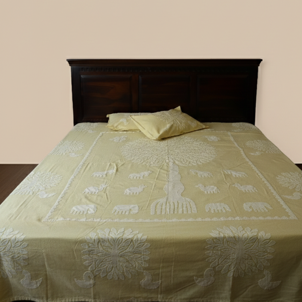 Bed with a green floral and elephant patterned bedsheet with pillows on a beige wall background