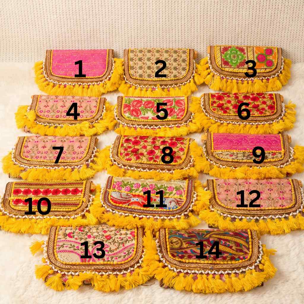 Set of 14 embroidered pouches with yellow fringes on a textured surface
