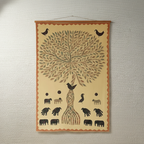 Decorative wall hanging with a tree design and various animals on a textured wall.