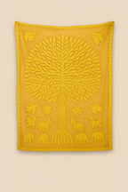 Yellow embroidered wall hanging with tree design on a beige background