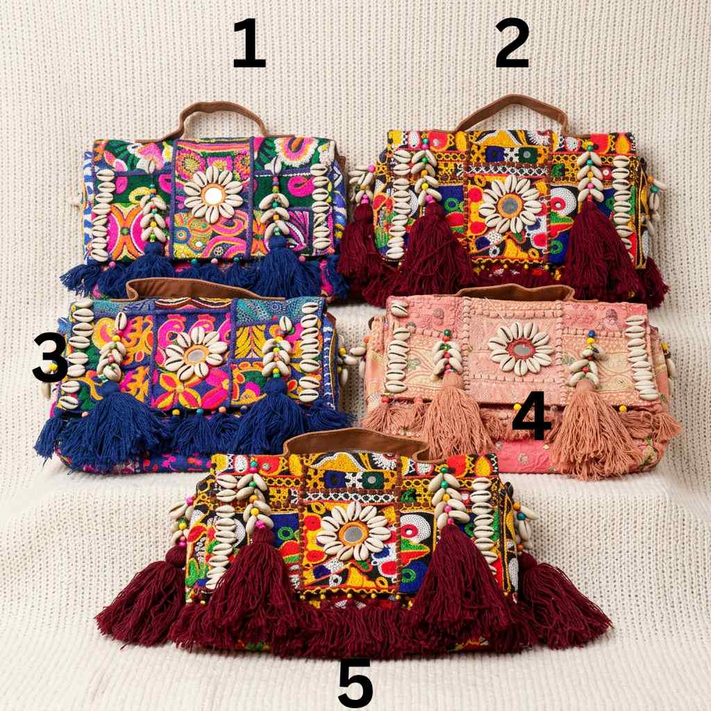 Colorful handbags with floral patterns and tassels on a light background