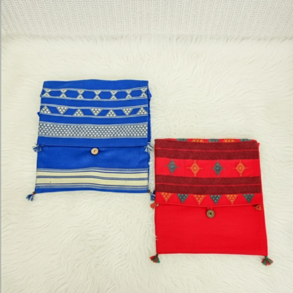 Two fabric bags, one blue and one red, with patterns on a white textured background.