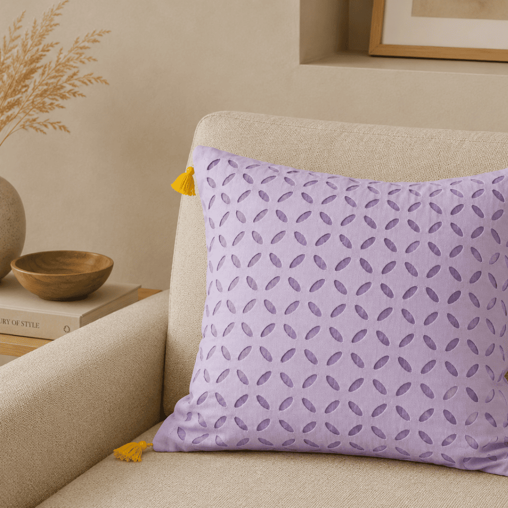 Lavender Appliqué Cutwork Cushion Cover on a sofa in a beige room setting
