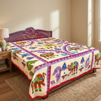 Colorful elephant-patterned applique bedspread on a bed in a bedroom setting.