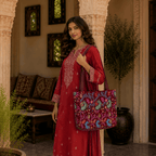 a woman carrying red suit set and a maroon embroidered bag