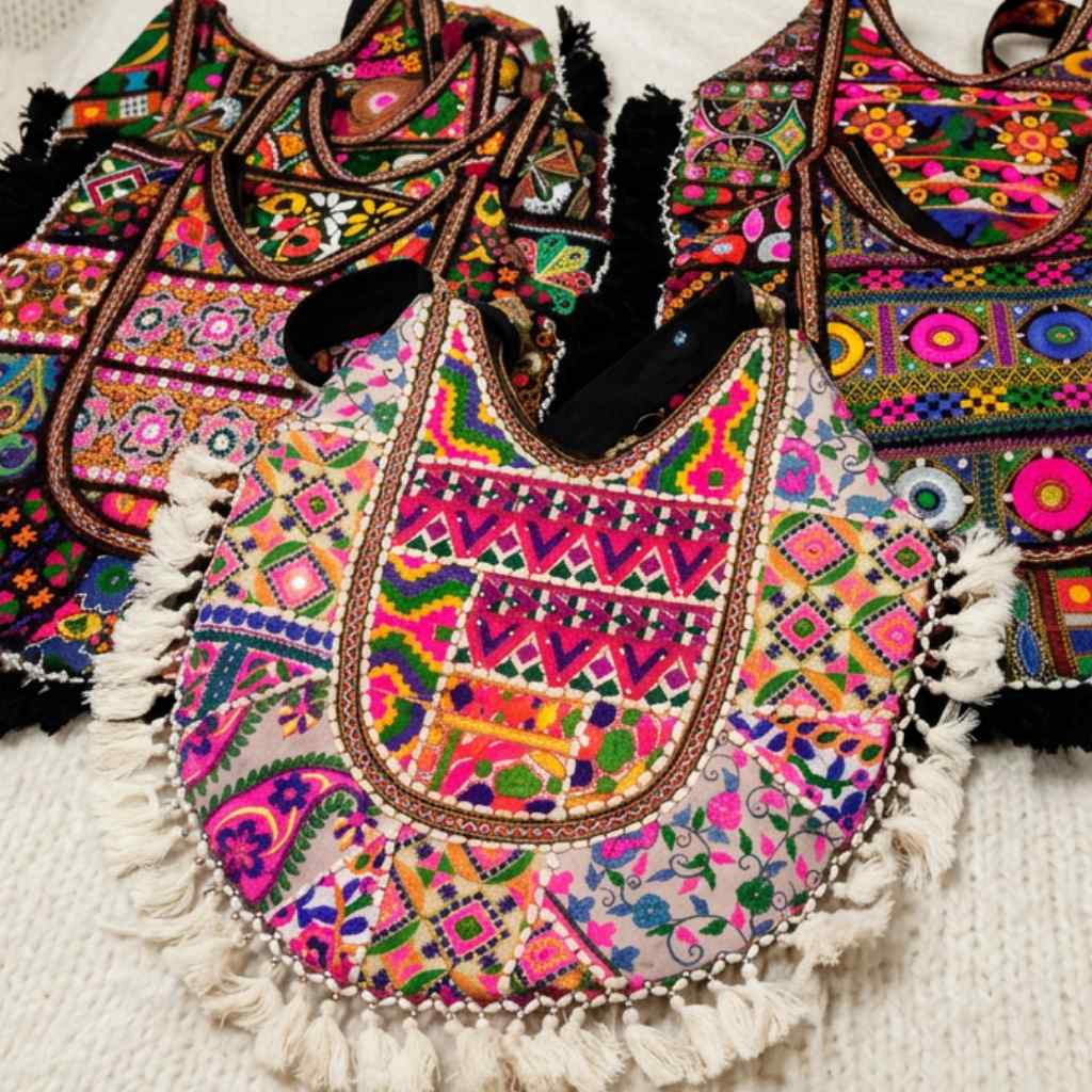 Colorful embroidered bags with intricate patterns on a textured surface