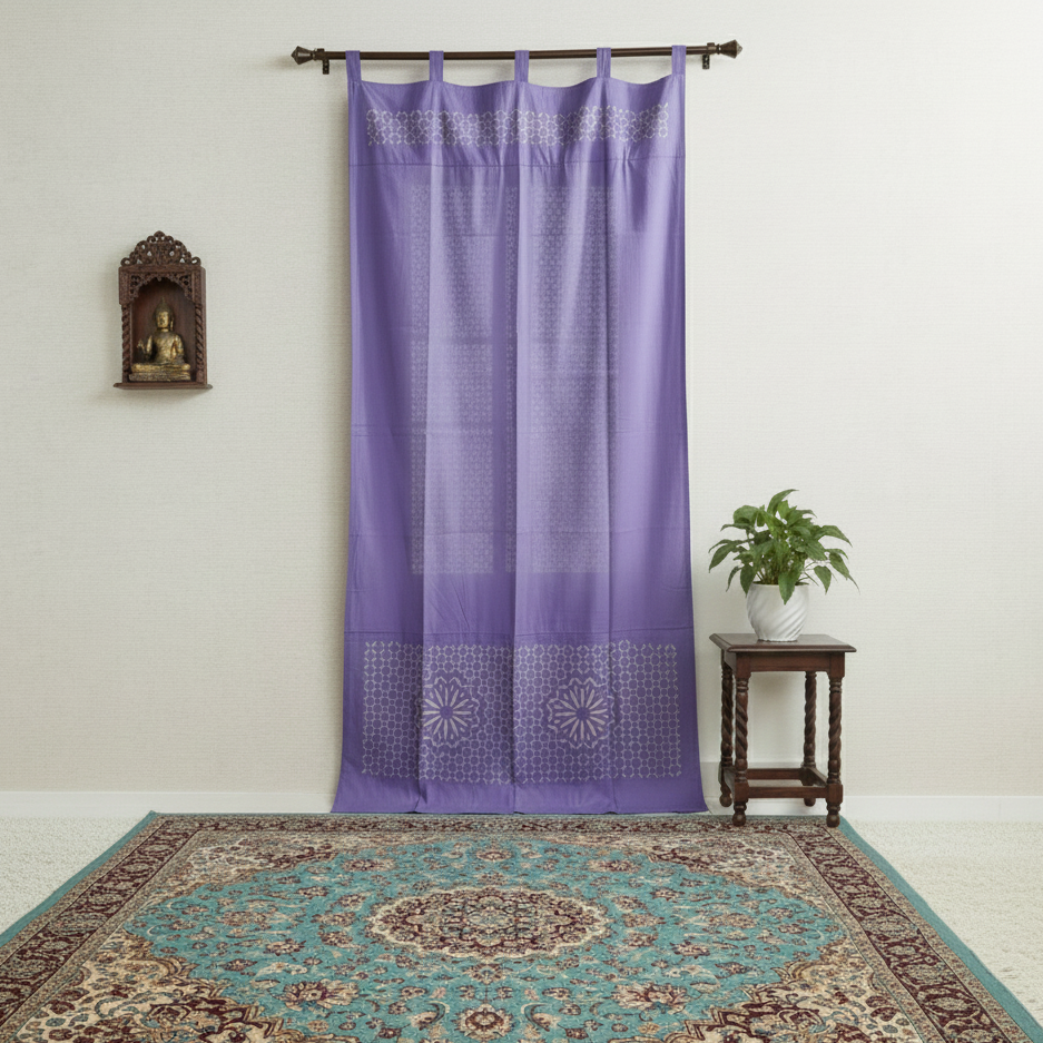 Purple curtain with decorative top hanging on a rod above a patterned rug.
