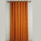 Orange curtain with a subtle pattern on a white background