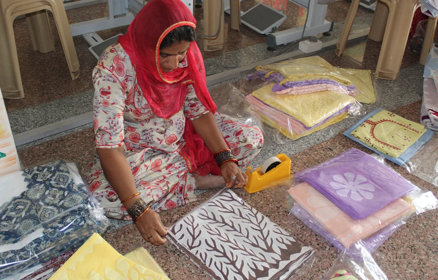 Woman working with fabric patterns on a floor
