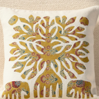 Decorative cushion cover with a tree and elephant design on a beige background
