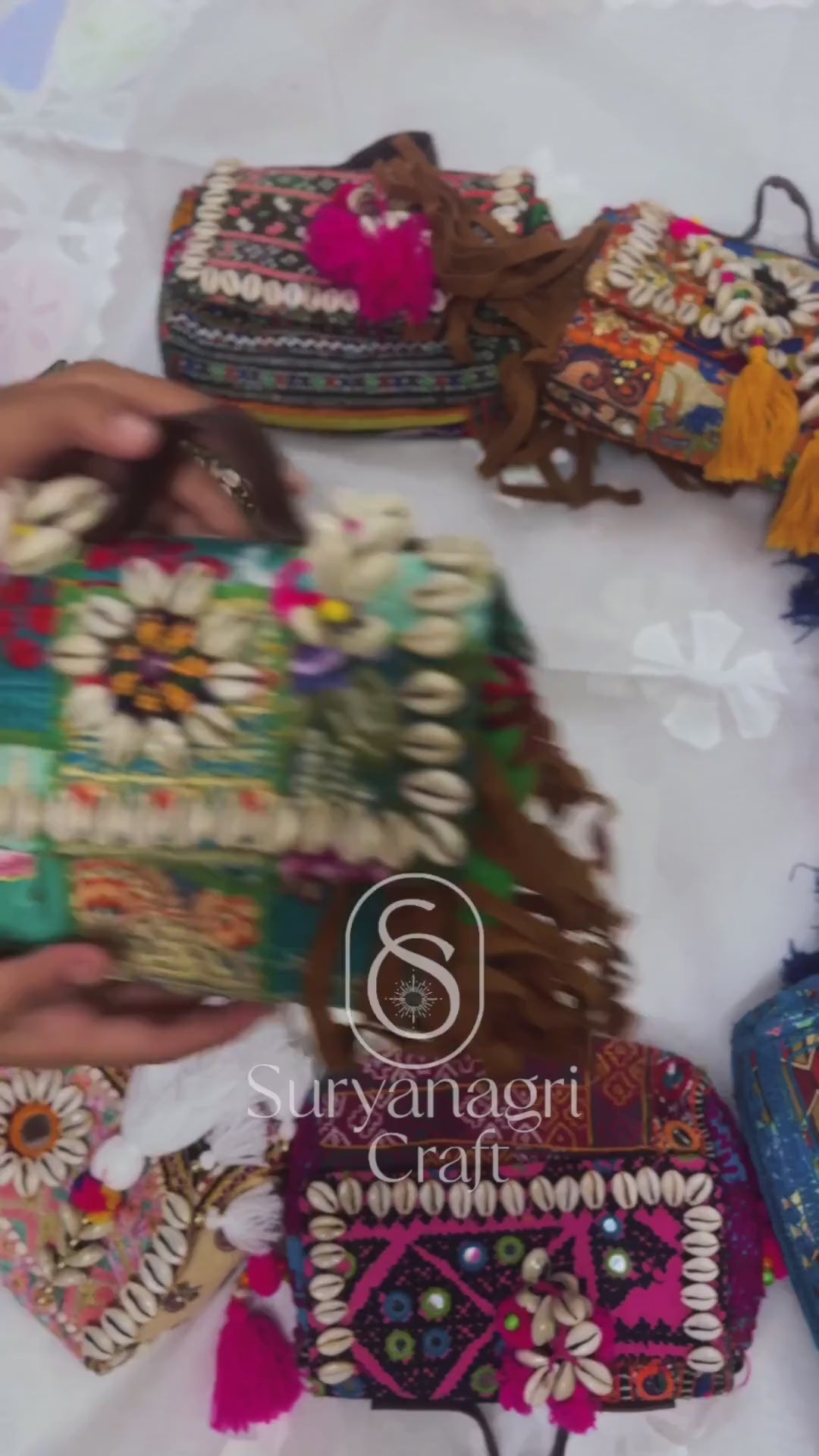 a video showing variety of colorful embroiderd boho bags